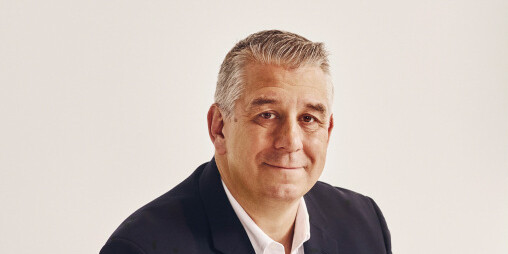 Headshot for Ben Semmes, wearing a dark suit and white dress shirt.